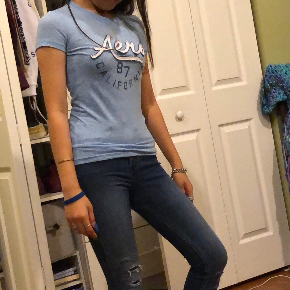 Blue shirt with design on it